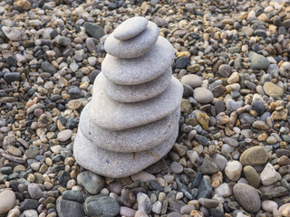 Fototapeta na wymiar Stone pyramid on beach