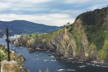 Green valley landscape on background dramatic. View sunlight ocean in trip holiday in basque island Gaztelugatxe. Panorama horizon of scenery foggy hills Northern Spain alps mountain. Travel mockup