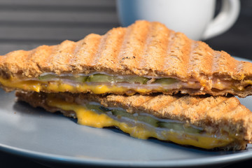 Pile of grilled sandwiches with cheese and ham.