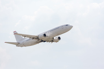 Fototapeta na wymiar white plane takes off from the runway