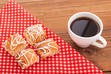 Coffee and biscuits on the tablecloth.