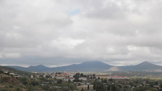 Clouds pass over a small desert mountain town on a fall day