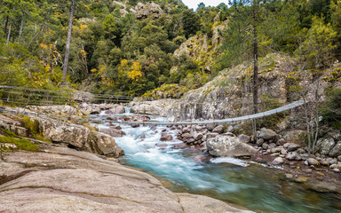 Steel rope bridge across La Figarella at Bonifatu in Corsica