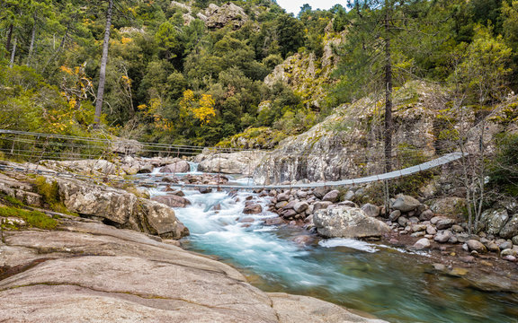Steel rope bridge across La Figarella at Bonifatu in Corsica