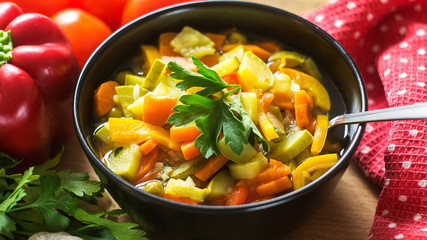 A bowl of traditional italian minestrone soup with ingredients