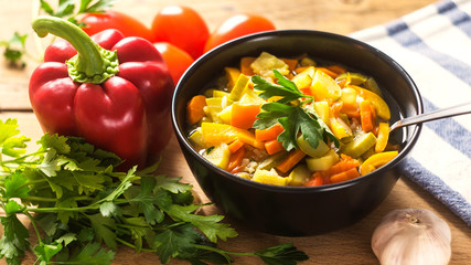 A bowl of traditional italian minestrone soup with ingredients
