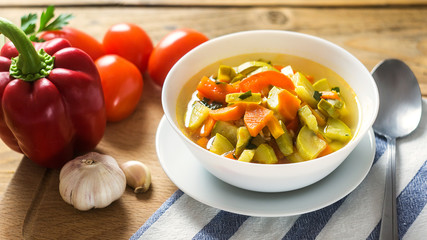 A bowl of traditional italian minestrone soup with ingredients