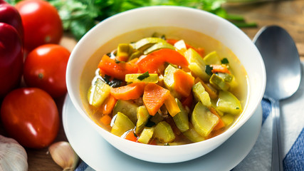 A bowl of traditional italian minestrone soup with ingredients