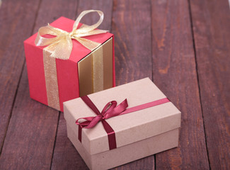 Gift boxes with bow on wood background