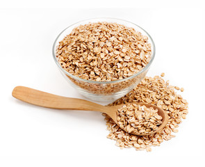 Golden oat flakes in bowl and spoon on white background. Healthy food. Top view, high resolution product