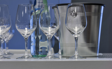 Empty wine glasses with ice bucket closeup