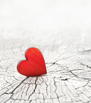 red heart on a cracked wooden background