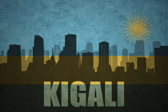 abstract silhouette of the city with text Kigali at the vintage rwandan flag