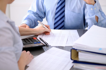 Bookkeepers or financial inspector making report, calculating or checking balance. Audit concept.