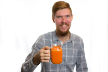 Fototapeta premium man holding a carrot juice diet is a healthy diet is useful