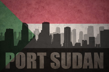 abstract silhouette of the city with text Port Sudan at the vintage sudanese flag