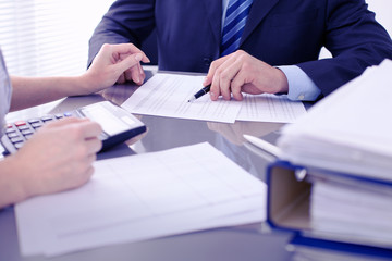 Bookkeepers or financial inspector making report, calculating or checking balance. Audit concept.