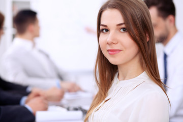 Portrait of a young business woman at  meeting.