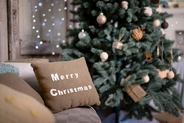 Happy new year decoration. Merry christmas decoration. Christmas interior, sofa, pillow, Christmas tree, new year