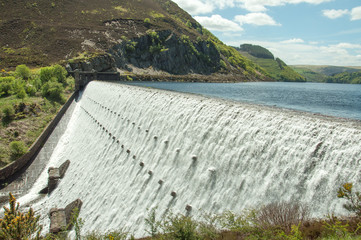 Elan valley and the Rhayader dams of Powys, Wales.

A summertime scene of water flowing over the...
