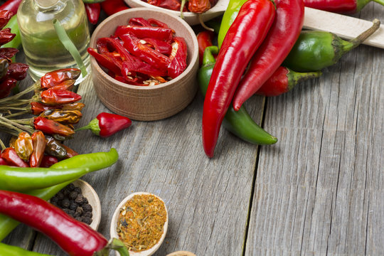 fresh red, yellow and green chilli on old wood background. selective focus image, space for advertising text  