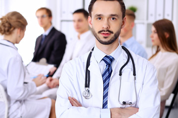 Fototapeta premium Friendly bearded male doctor with patients