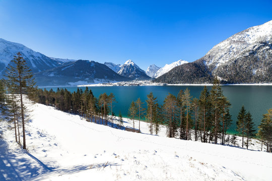 Idyllic snow landscape with mountain lake, Achenlake, Achensee, Austria, Tirol.