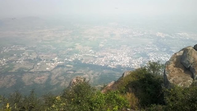 Thousands Dragonflies (Odonatoptera) hover on top of sacred mountain Tiruvannamalai (Tamilnad, India), where during holidays and to monastery rises thousands of Indian pilgrims
