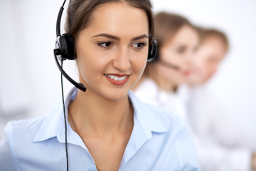 Call center. Focus on beautiful woman in headset