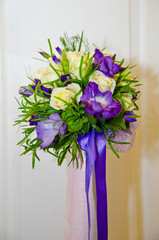 Charming wedding bouquet of white roses and purple irises. Floristics.
