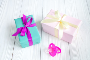 birth of baby - boxes for gifts on wooden background