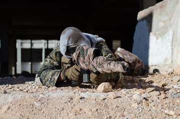 Sniper aim target with scope kneeling position 