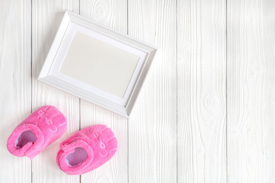 baby shower - blank picture frame on wooden background