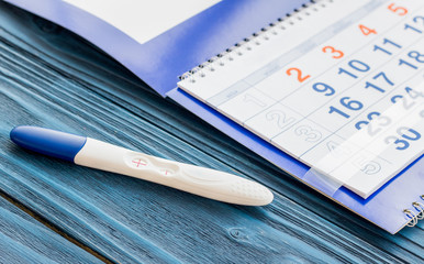 Positive pregnancy test with calendar