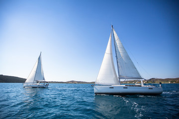 Sailing. Racing yacht in the Aegean Sea on blue sky background. Luxury Lifestyle.