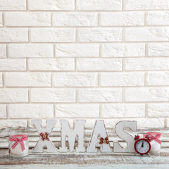 Christmas decorations. Christmas background. Watch, candle and Christmas text on wooden table.