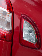 Headlights and hood of sport red car with silver stars