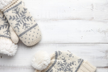 Fototapeta na wymiar Winter background with knitted mittens and cap