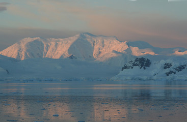 Sunset & alpenglow, mountains and mirror - calm ocean,Paradise harbor, Antarctica