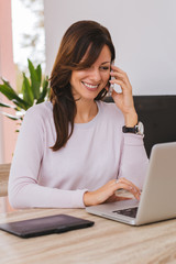 Business concept - businesswoman talking on the phone in office