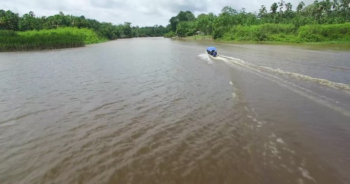 Boat driving down the amazon river