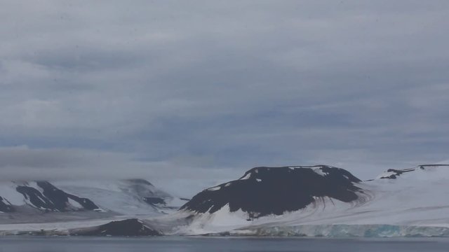 Severe high Arctic latitudes. Franz-Josef Land. Ziegler island with glaciers, snowfields and glacier-smoothed mountains

