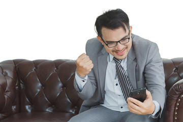 Businessman happy smiling, wearing suit and using modern smartph