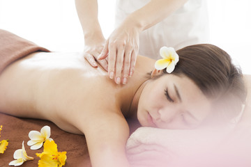 The woman is undergoing a back massage