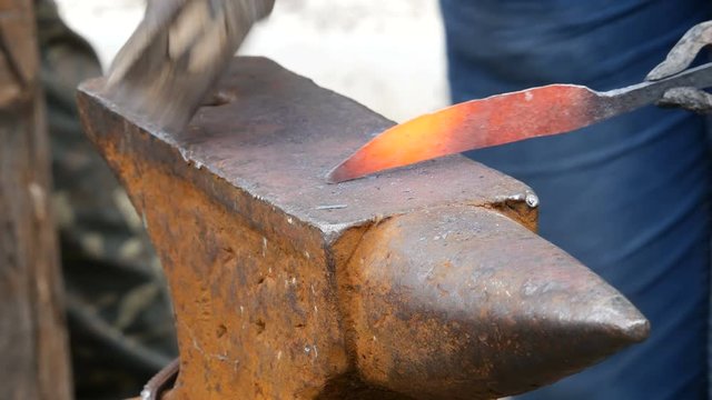 Blacksmith Working on Metal on Anvil