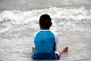 Fototapeta premium Ethnic Boy Sitting in the Water