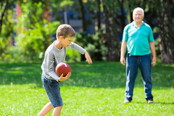 Grandson And Grandfather Playing Rugby