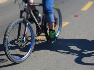 low angle view of cyclist riding mountain bike on asphalt trail