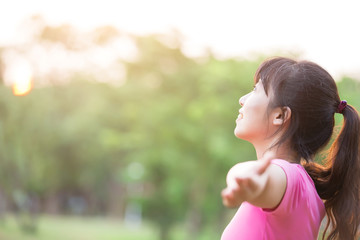 young woman raising her arms