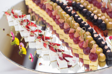 Catering banquet table with baked food snacks, sandwiches, cakes, cups and plates, self serve, open...
